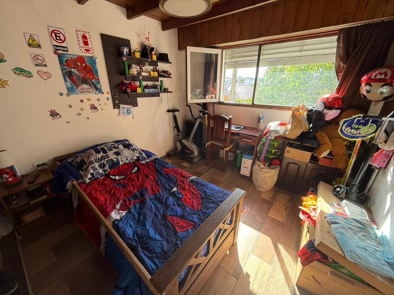 Escritorio amplio con ventana al verde, usado como cuarto